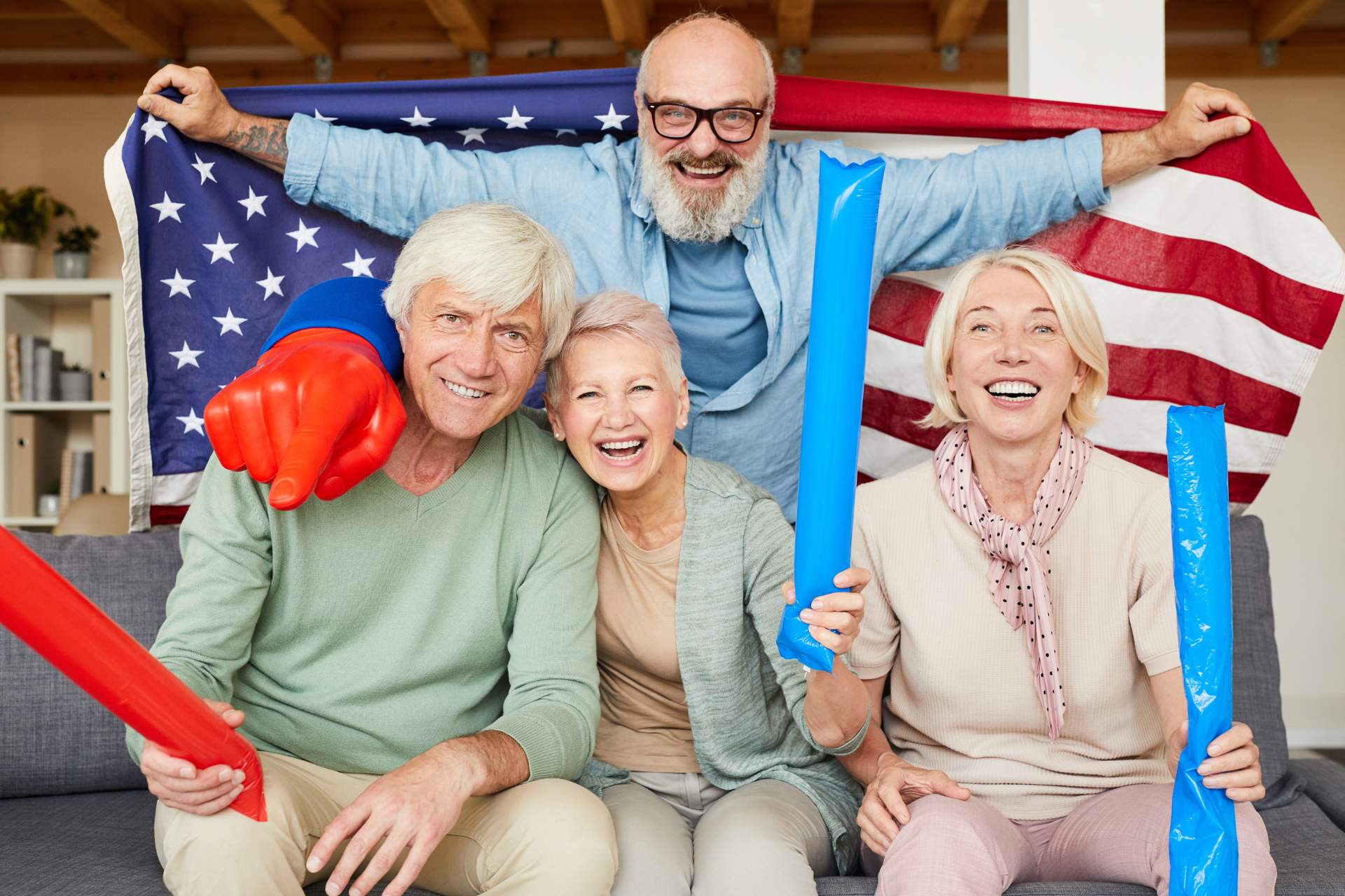 Group of seniors with festive red, white, and blue decorations and an American Flag.